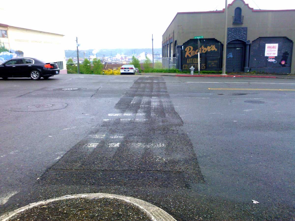 City of Tacoma crews removed unauthorized crosswalk markings at 6th & St Helens.