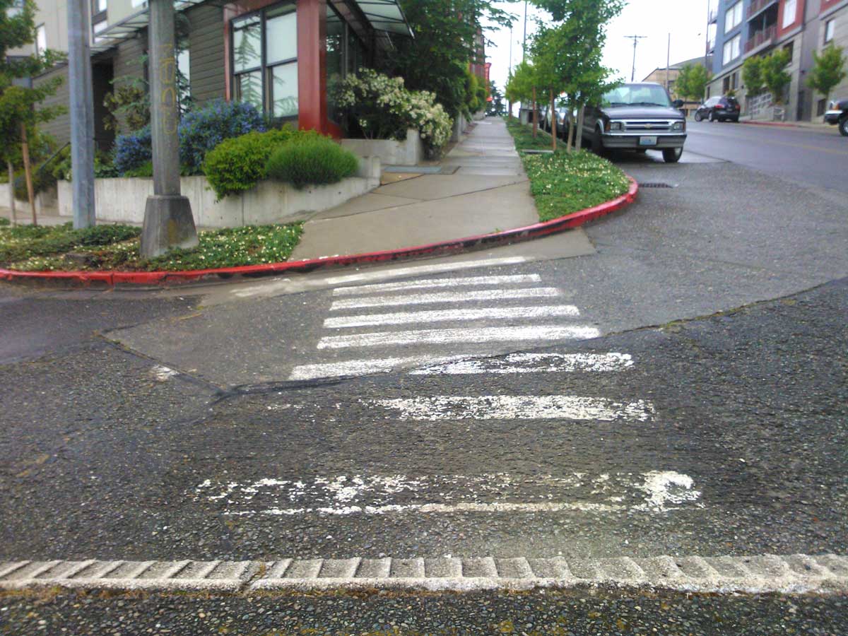 City of Tacoma crews removed unauthorized crosswalk markings at 6th & St Helens.